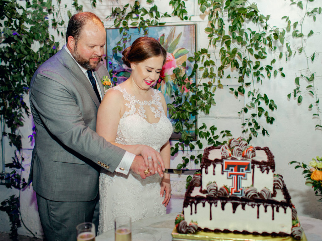 WED bride and groom cutting texas tech cake
